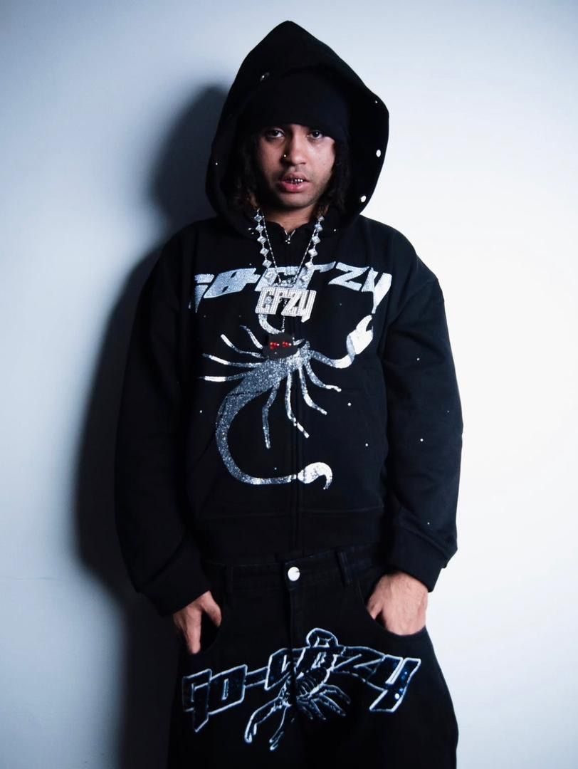 Suono Sai in a black hoodie with a rhinestone scorpion graphic