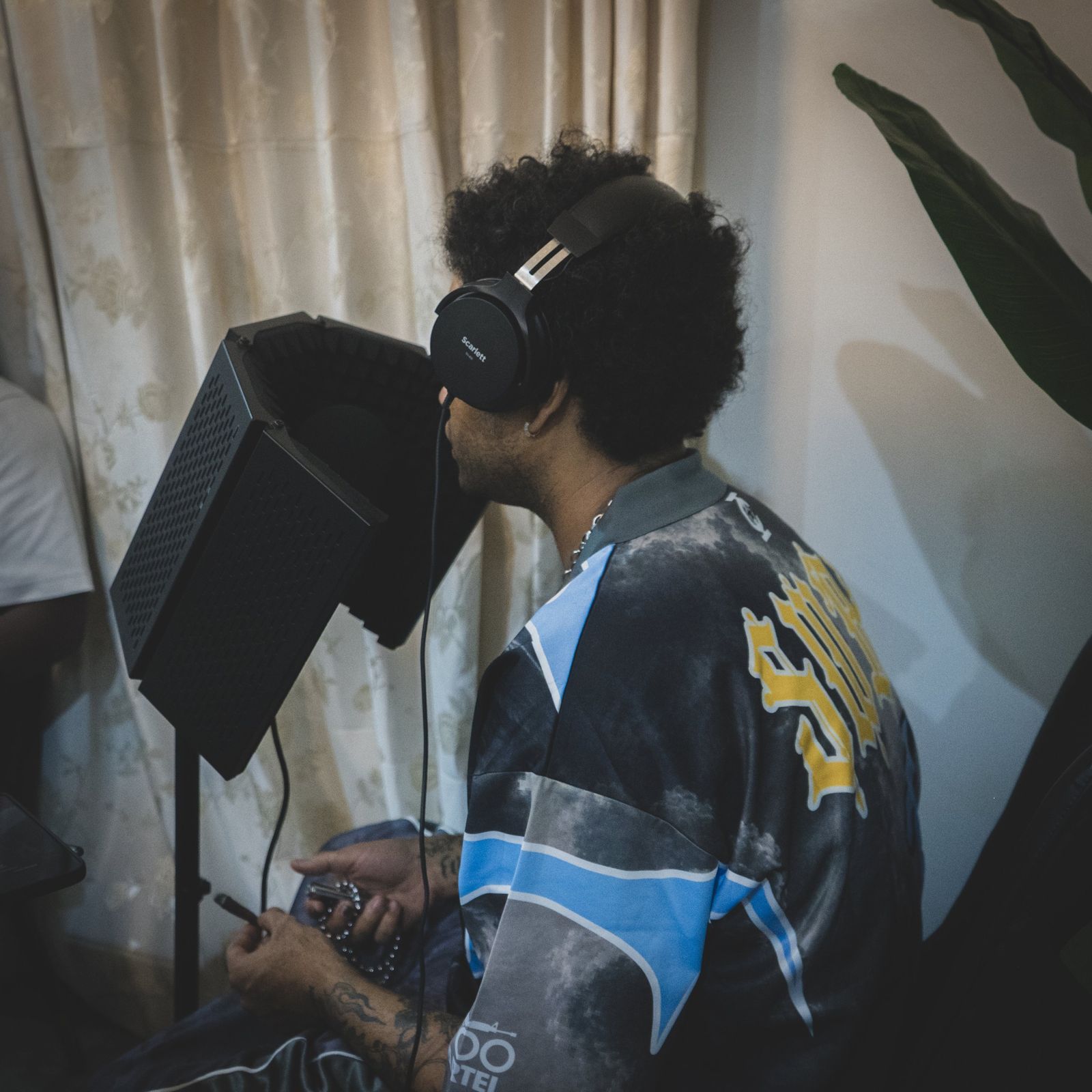 Suono Sai recording in the studio with headphones